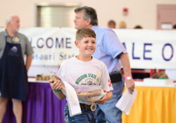 4-H member holding reserve grand champion ham