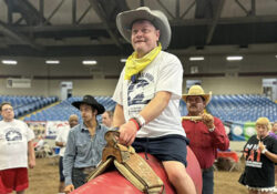 Man riding on imitation bull at the Exceptional Rodeo