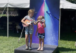 Kids playing with guitar at photo station.